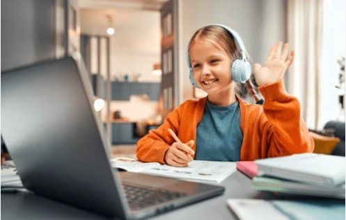 Student waving at laptop during an online tutoring session